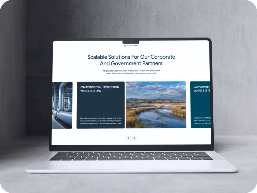 Laptop on a concrete surface displaying a website with the header "Scalable Solutions for Our Corporate and Government Partners." Features images of water systems.