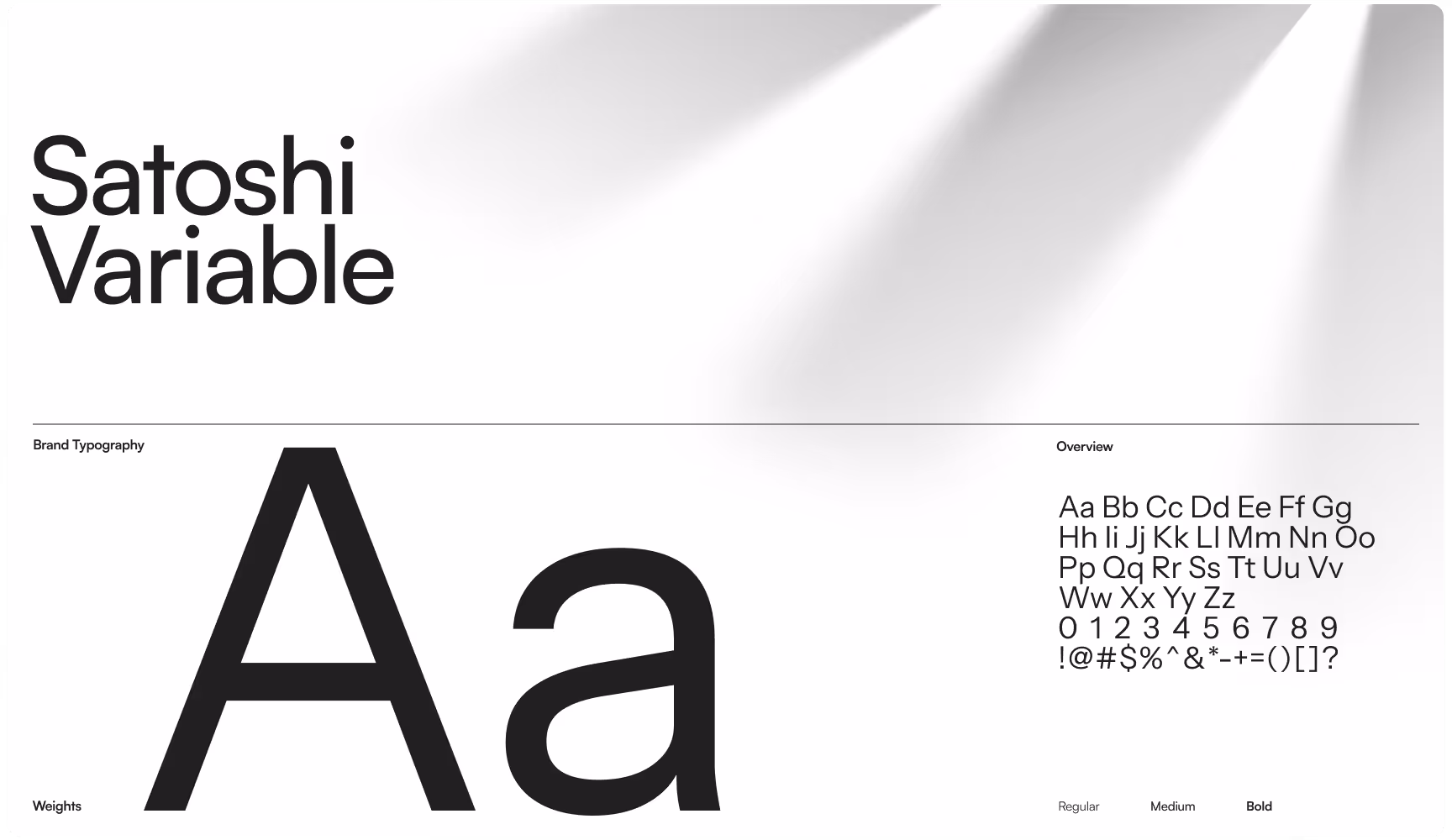 Satoshi Variable typography showcase featuring large “Aa” letterforms, full alphabet, numbers, and symbol set on a minimalist gray layout.