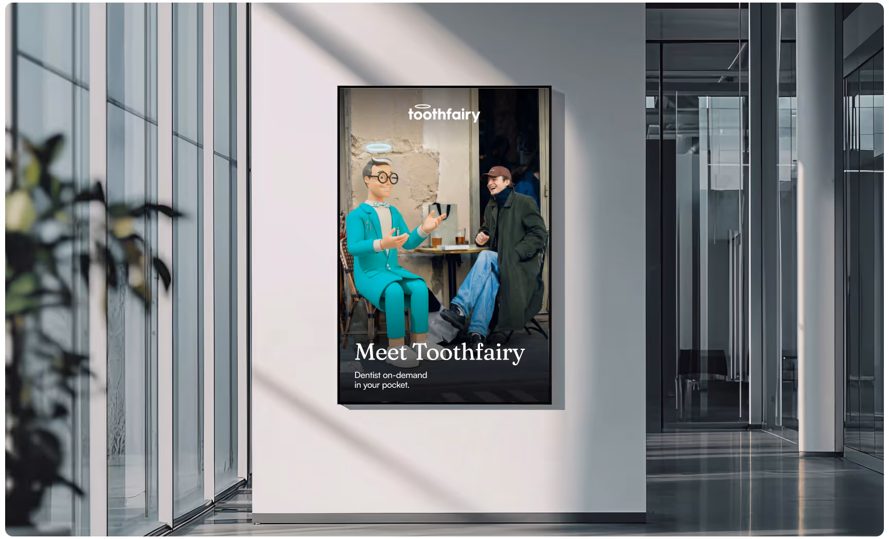 Modern office interior featuring a Toothfairy promotional poster with a friendly haloed mascot chatting with a person at a café table, alongside the headline “Meet Toothfairy,” promoting on-demand dental consultations and accessible digital healthcare.