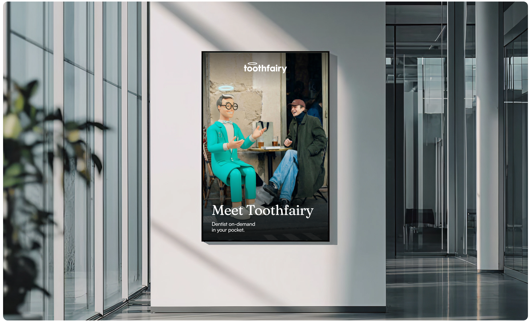 Modern office interior featuring a Toothfairy promotional poster with a friendly haloed mascot chatting with a person at a café table, alongside the headline “Meet Toothfairy,” promoting on-demand dental consultations and accessible digital healthcare.