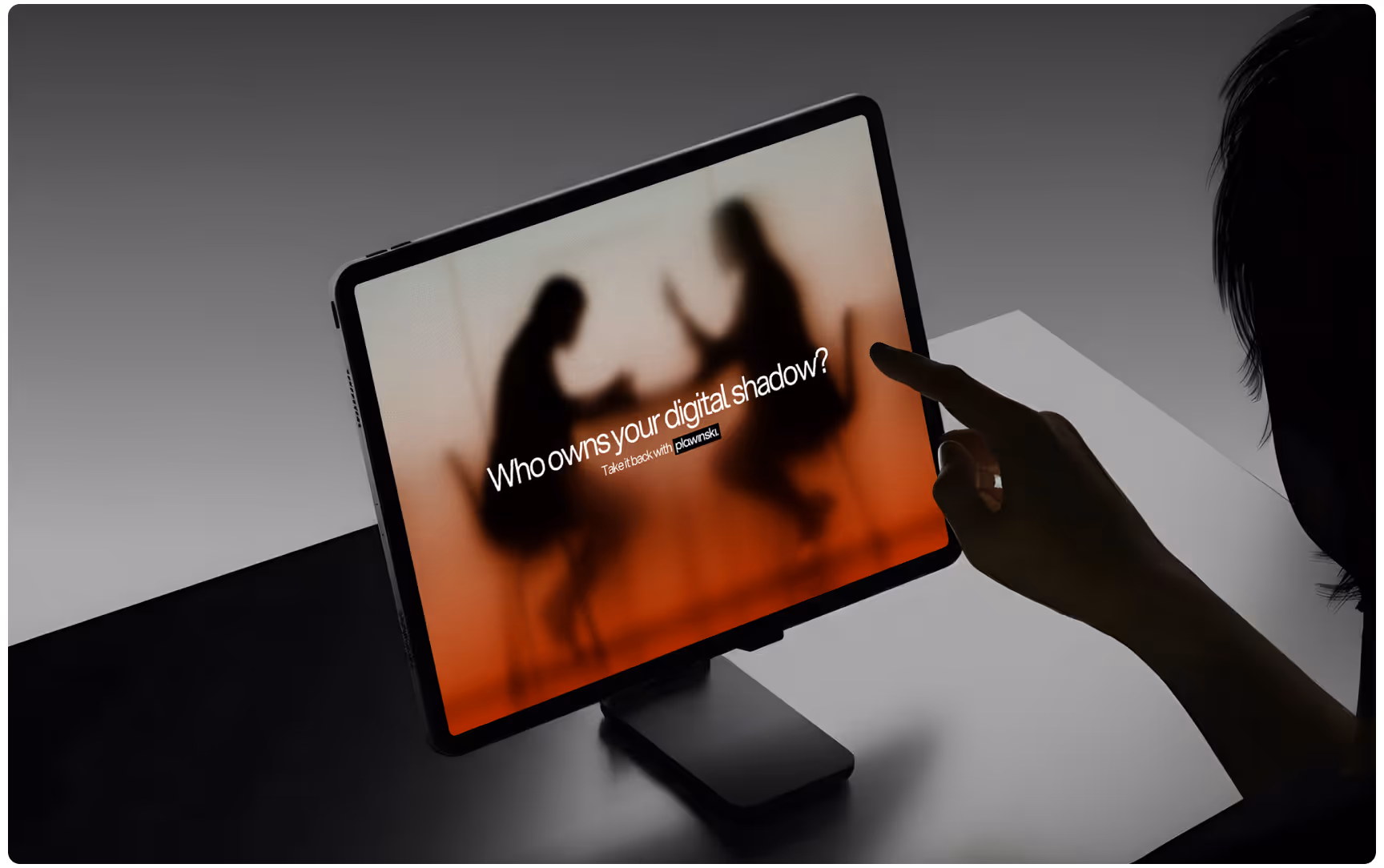 Tablet displaying a Plawinski digital privacy campaign with the message “Who owns your digital shadow?” over blurred silhouettes, while a user interacts with the screen, highlighting data privacy, digital rights, and modern legal branding.