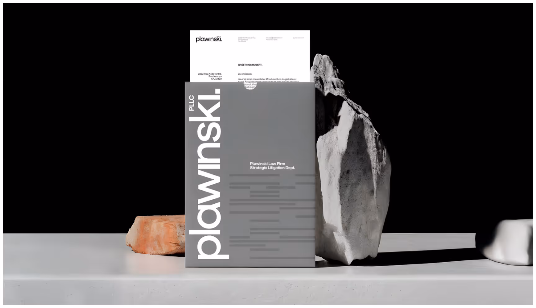 Minimalist law firm stationery mockup featuring a gray Plawinski PLLC document folder with a branded letterhead, clean typography, and sculptural stone elements, showcasing modern legal branding and professional corporate identity.