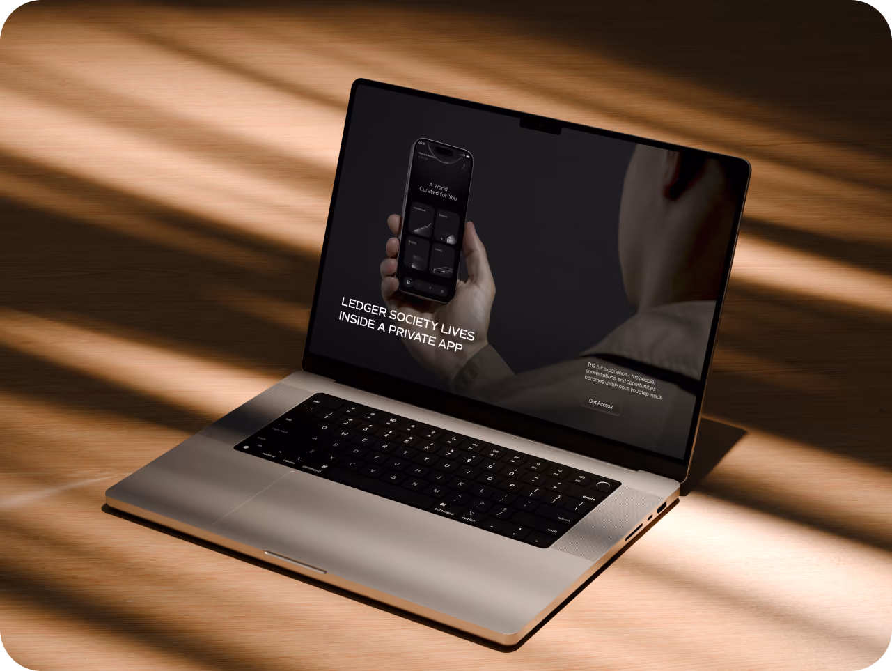 Premium laptop mockup on a warm wooden desk, displaying a dark Ledger Society private-app webpage with a smartphone image and the headline “LEDGER SOCIETY LIVES INSIDE A PRIVATE APP.” Soft sunlight and shadows create a sophisticated, high-end atmosphere.