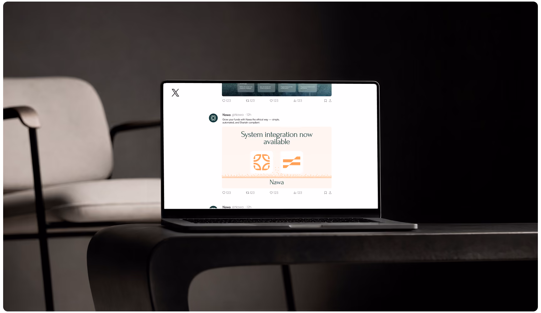 Laptop displaying a “System maintenance now available” message sits on a dark table beside an empty chair, creating a quiet, moody workspace scene.