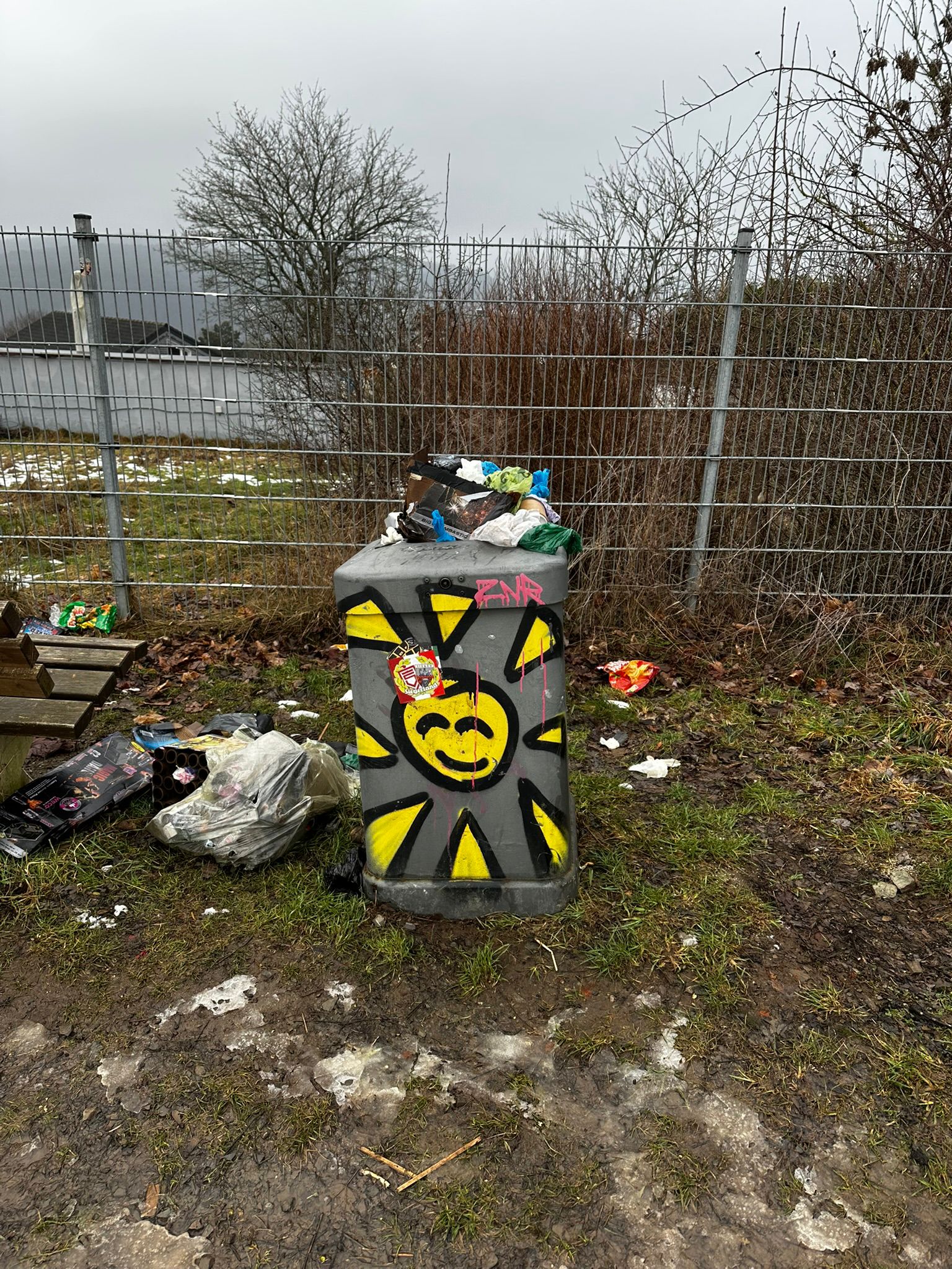 Smiley-Sonne auf einem Mülleimer trotz herumliegendem Müll – Symbol für die nachhaltige Wirkung einer Lachyoga Ausbildung und innere Freude im Alltag