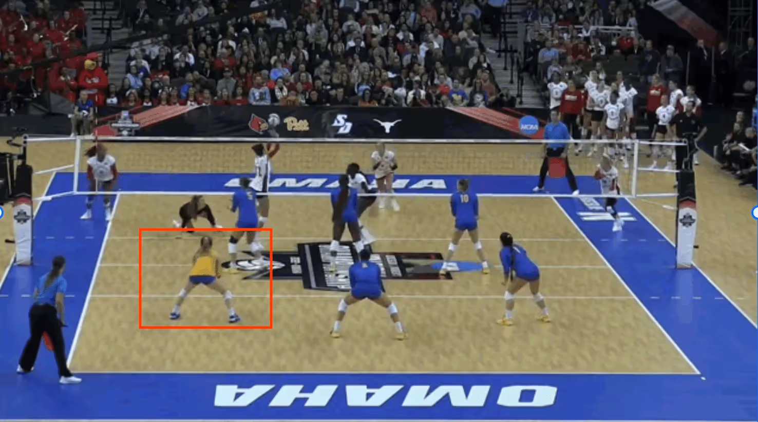 A libero playing in the left back position on the volleyball court