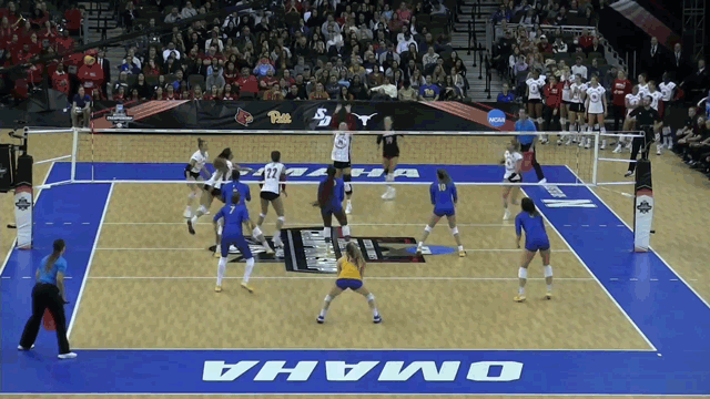 A picture showing a libero in volleyball playing middle back.