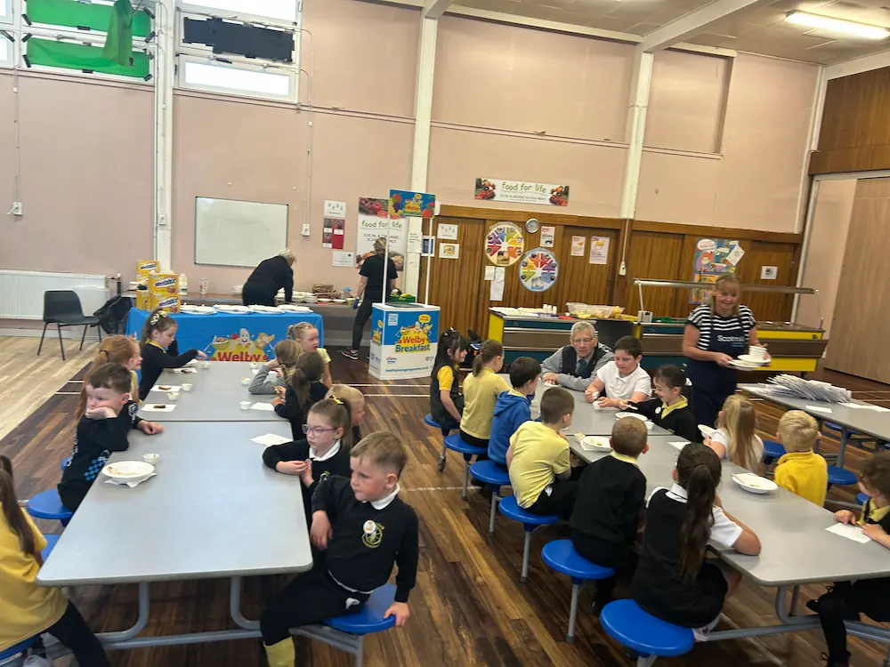 Logan Primary School pupils having breakfast in the school hall