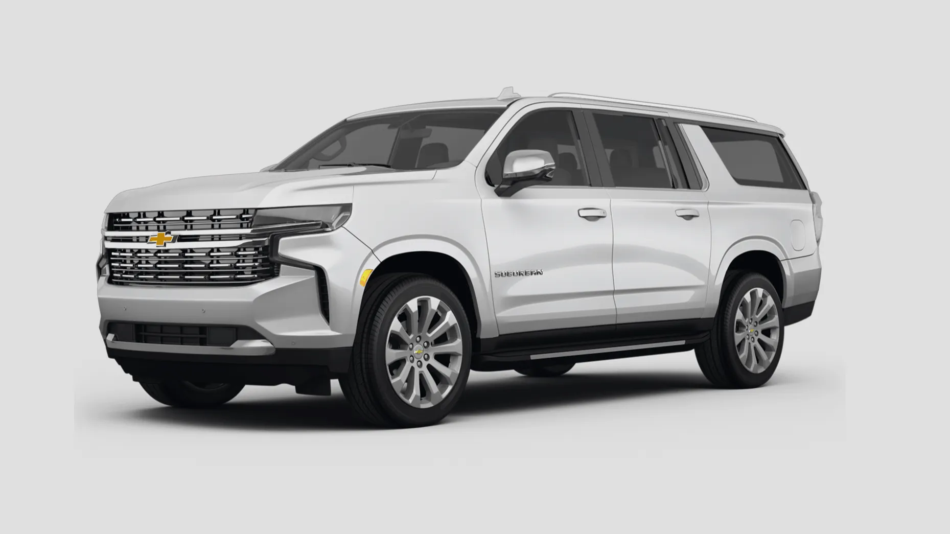 Black vintage Chevrolet El Camino with racing decals driving on a desert highway.