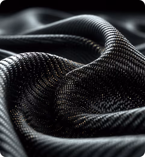 Close-up of shiny black carbon fiber fabric with detailed texture and light reflections.
