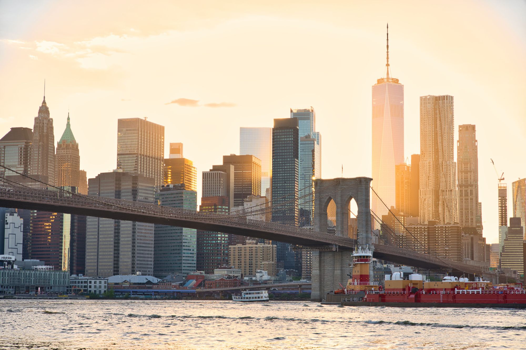 Lower Manhattan skyline and the Brooklyn Bridge at sunset
