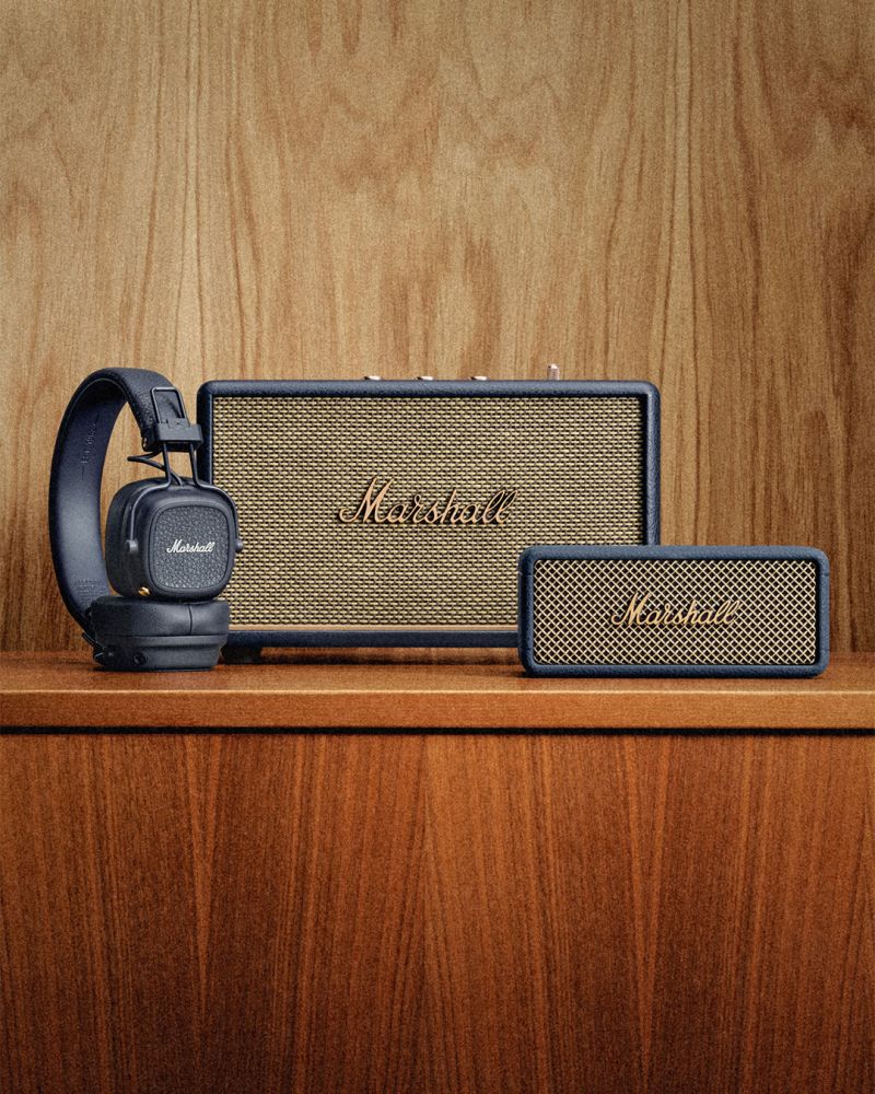 Three Marshall products coated in Midnight Blue standing on a desk