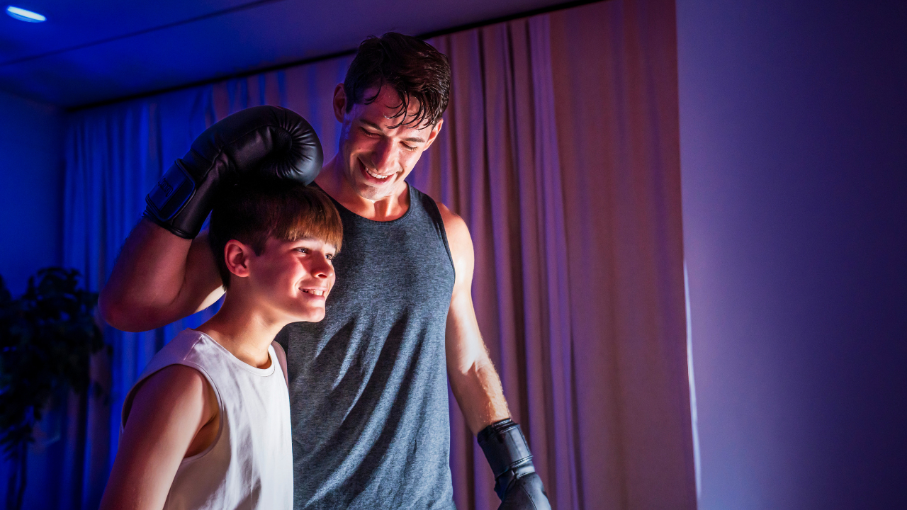 Parent and child enjoying a safe boxing workout together with guided training and family fitness activities.