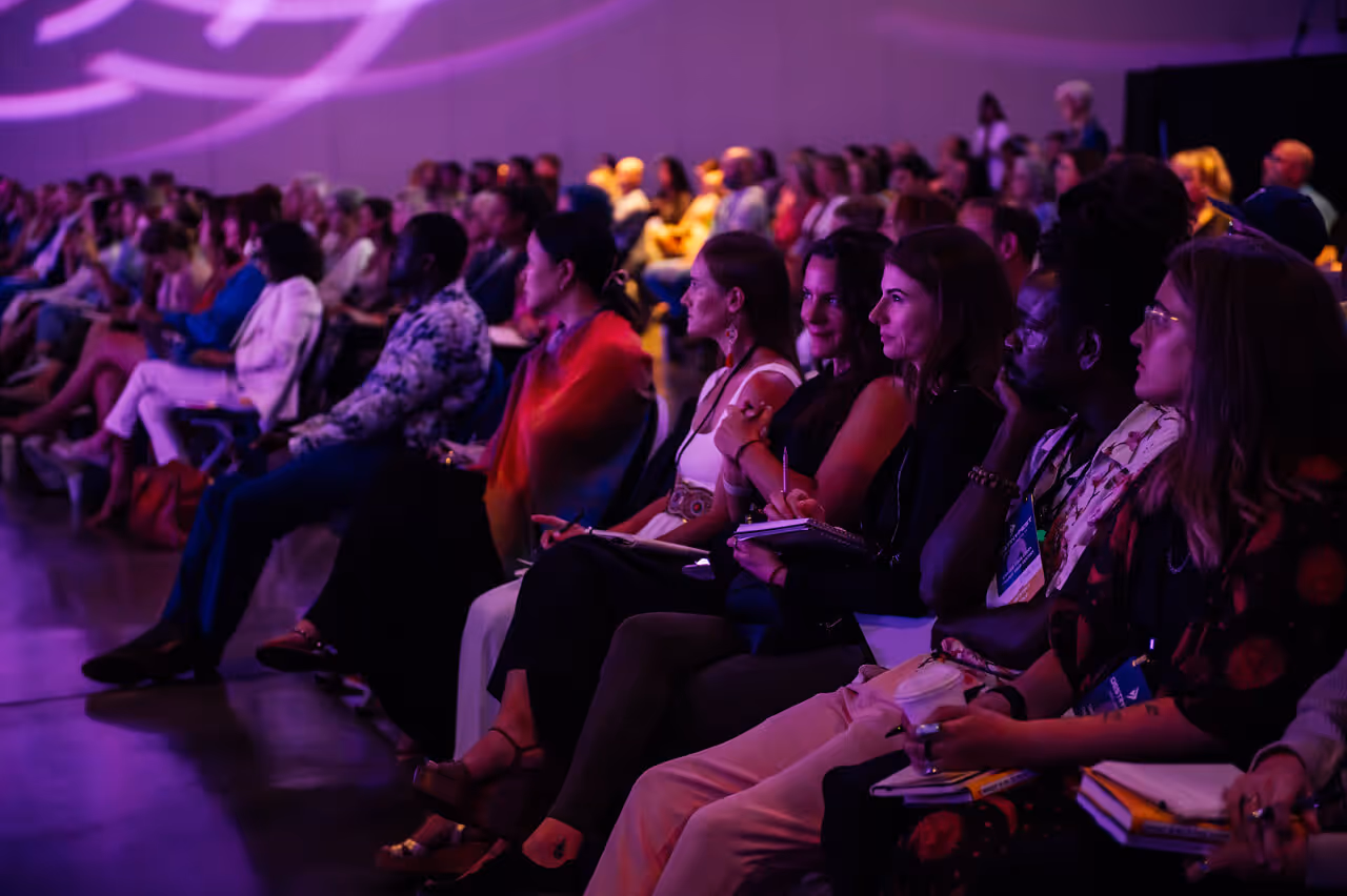 A large group of people sitting in a room.