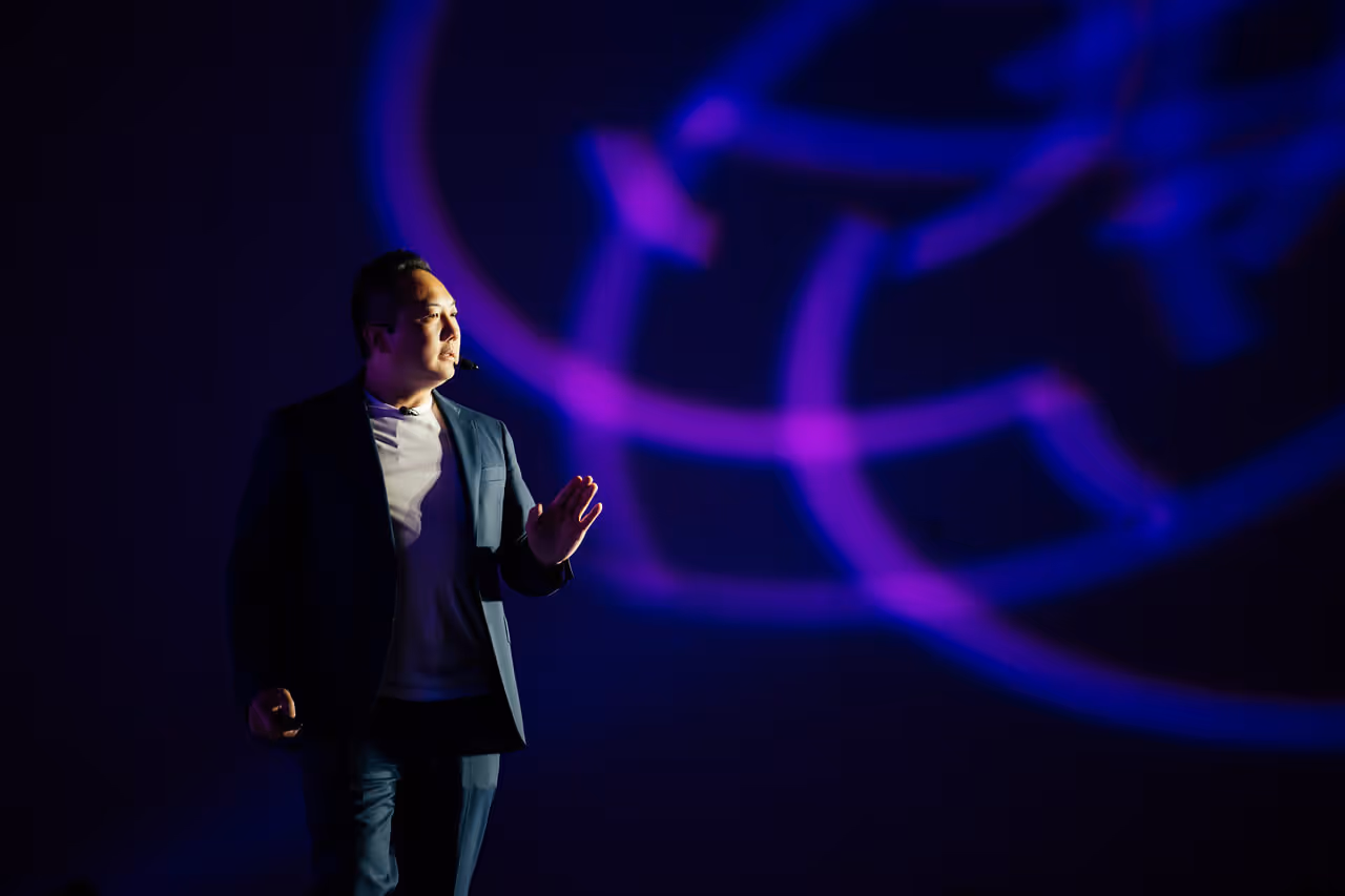 A man standing in front of a purple light.