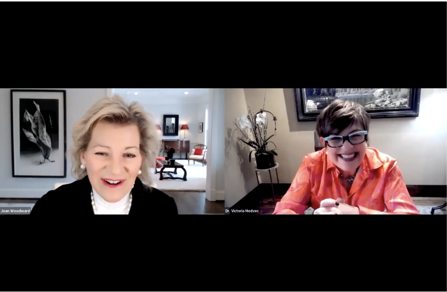 Two businesswomen smiling on a video call