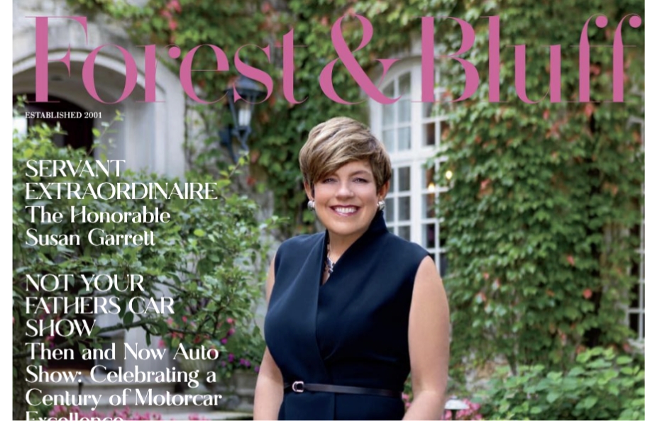 The cover of an issue of Forest & Bluff magazine featuring a woman wearing dark blue in front of a house with green vines