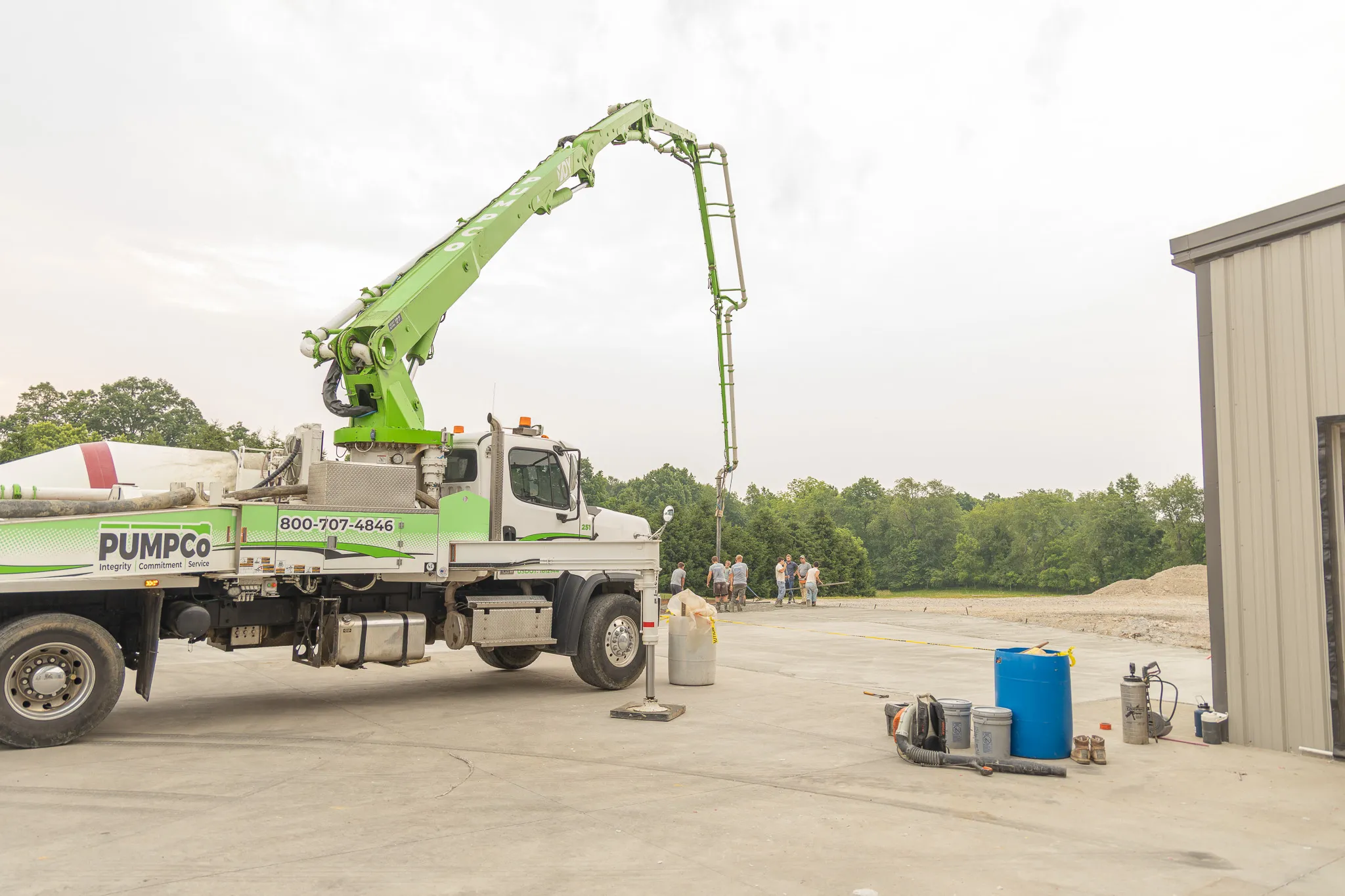 boom truck with workers in background