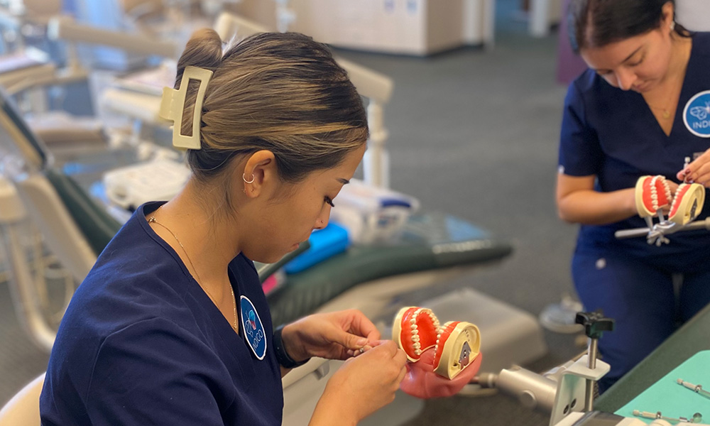 Dental assistant practicing procedures