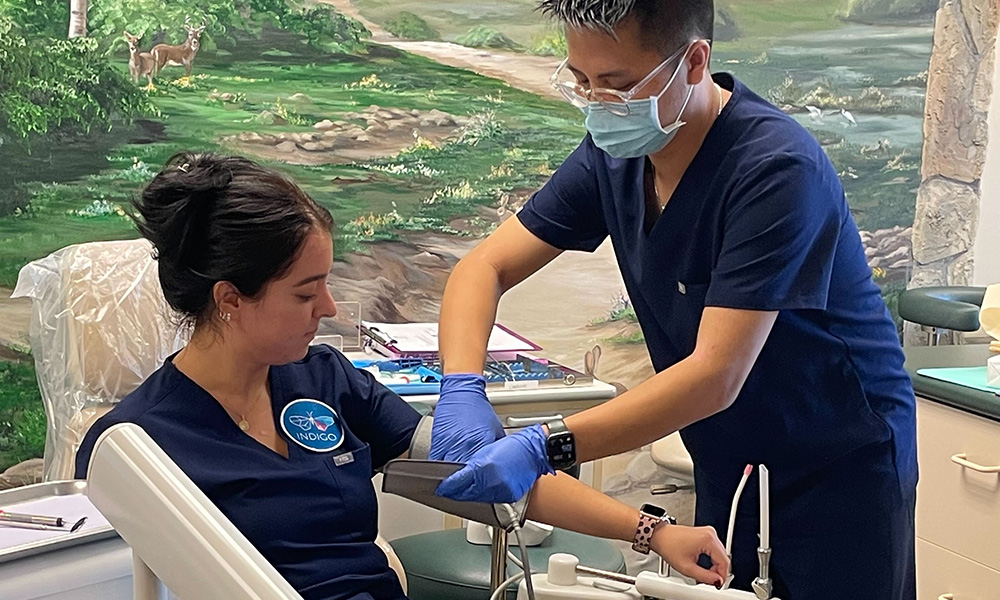 Dental assistant student taking blood pressure