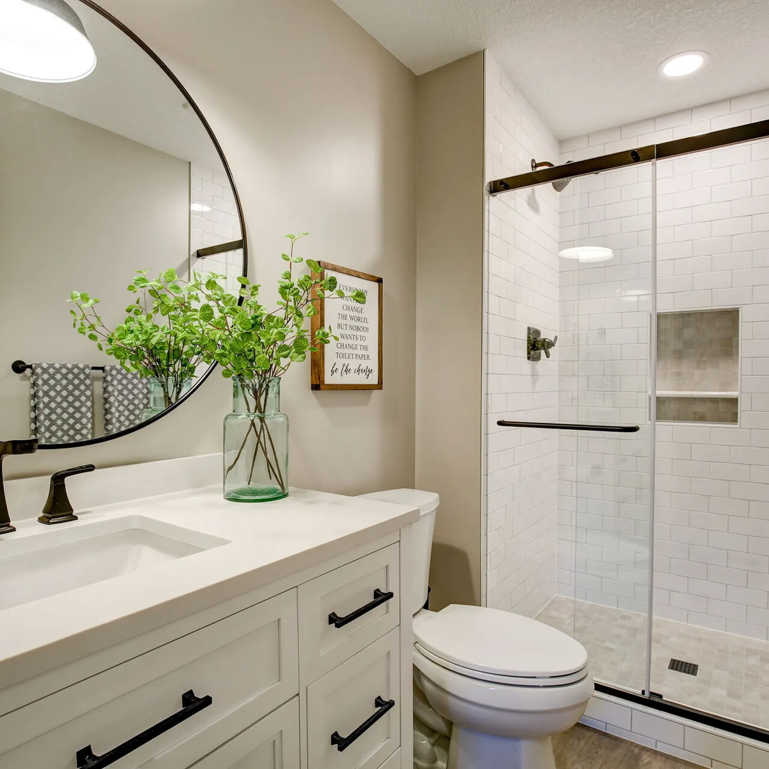 Bathroom remodel with recessed ceiling lights and updated vanity lighting.