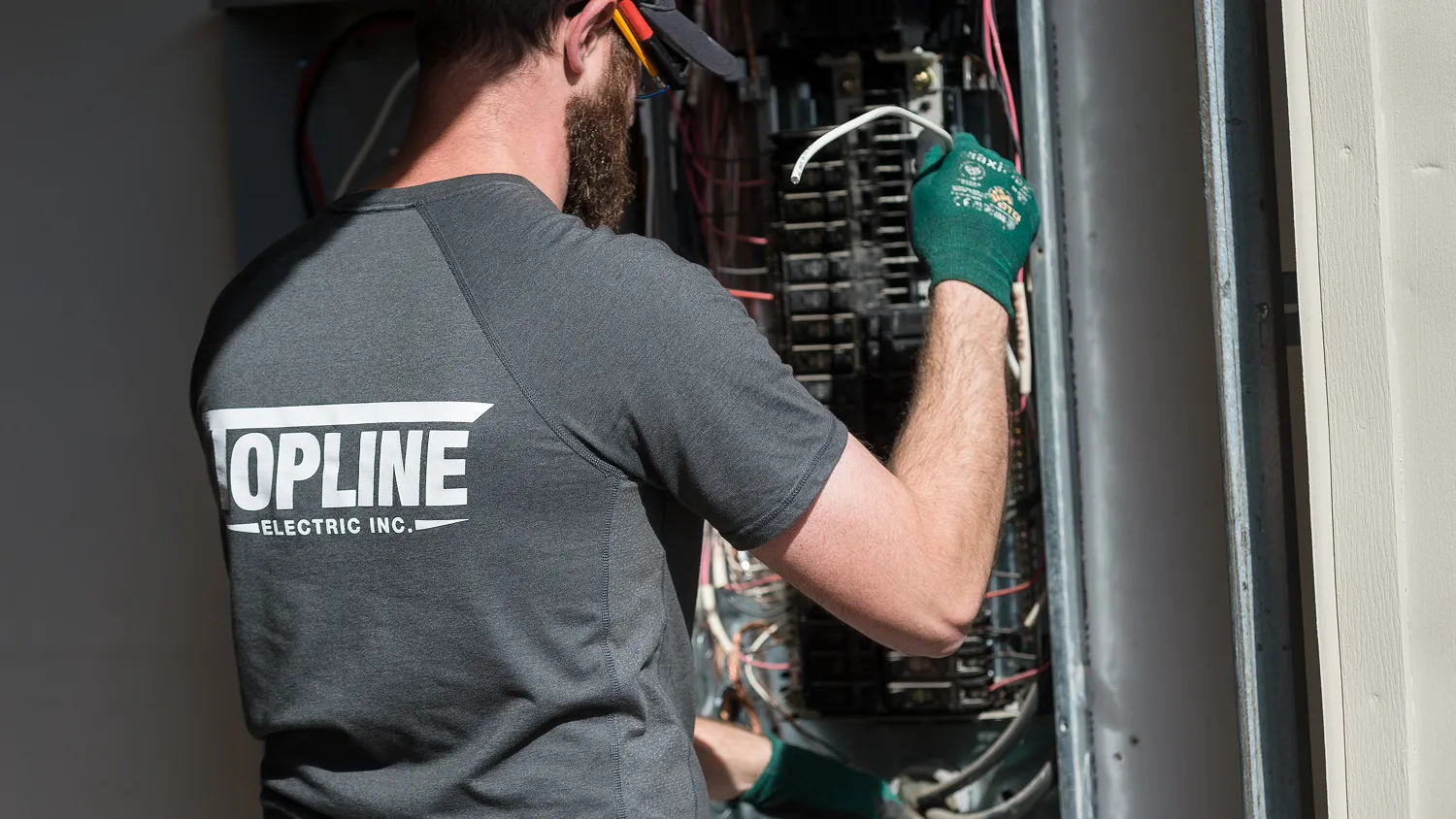 Top Line Electric electrician performing an electrical panel upgrade.