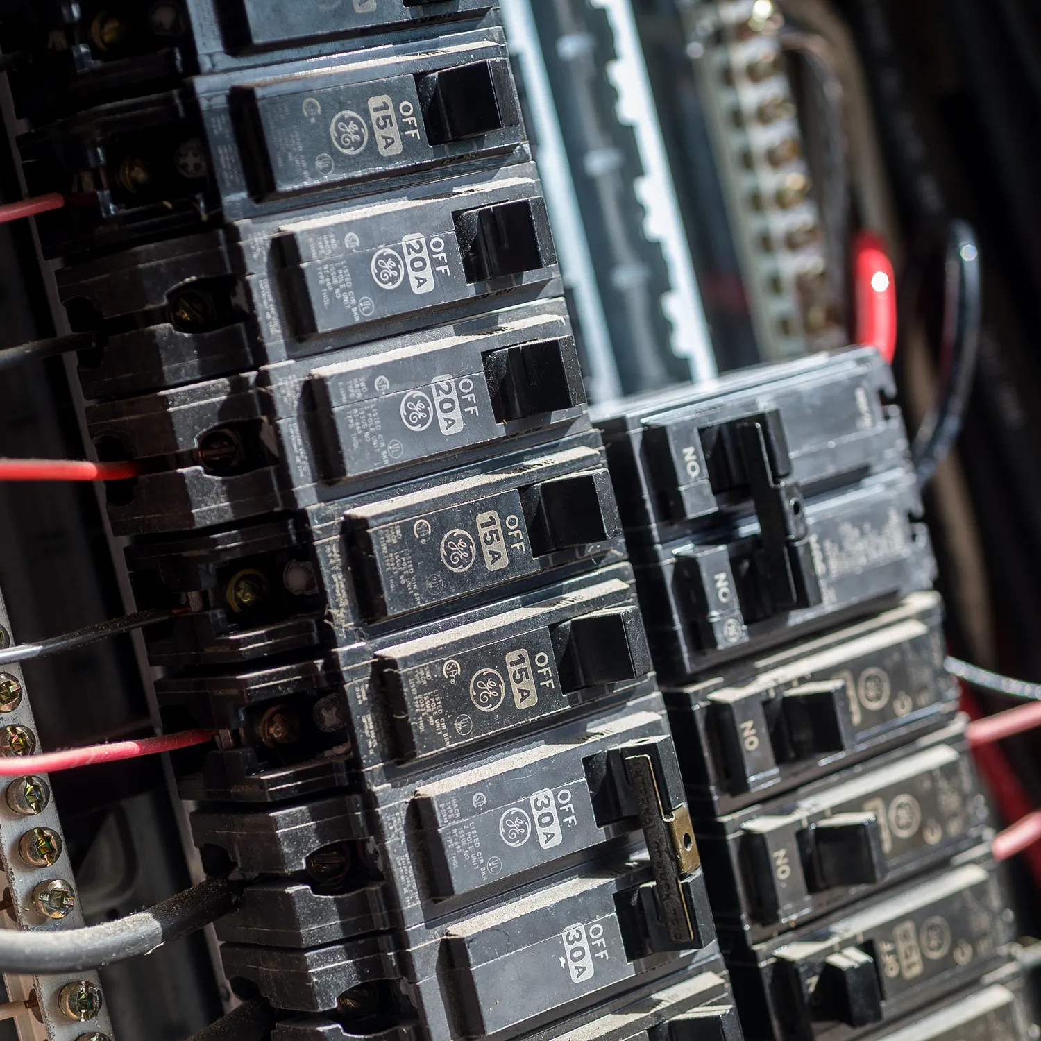 Close-up of a residential electrical panel with circuit breakers.