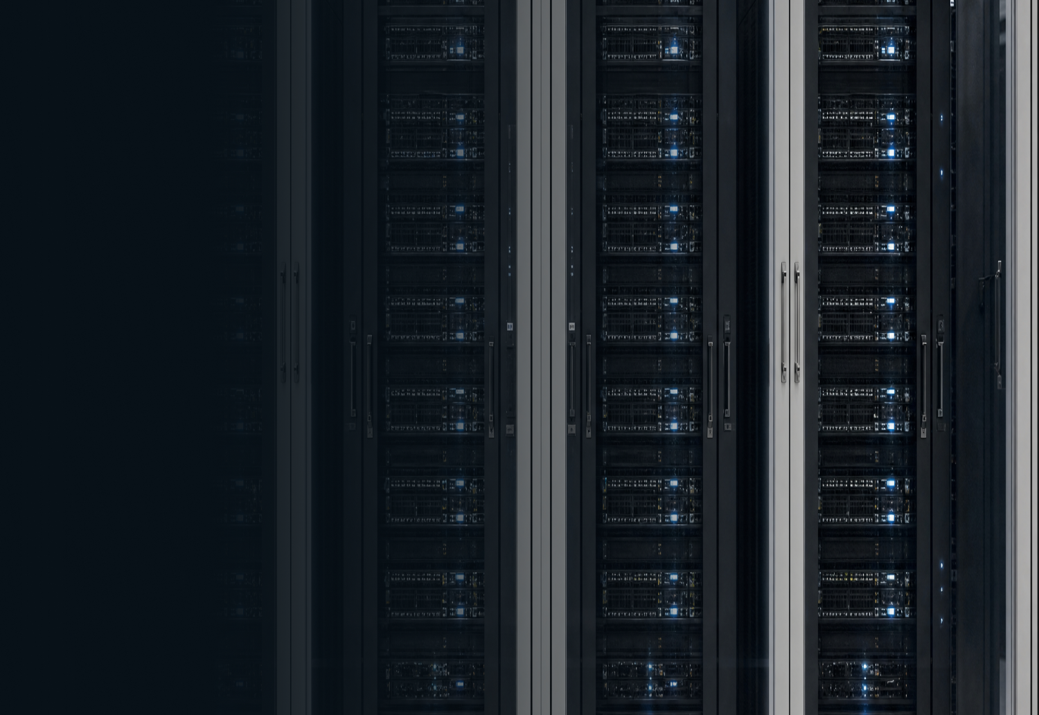 Close-up of server racks with blinking lights in a blue-lit data center hallway.
