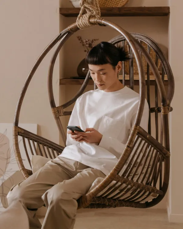 Women in chair looking at phone