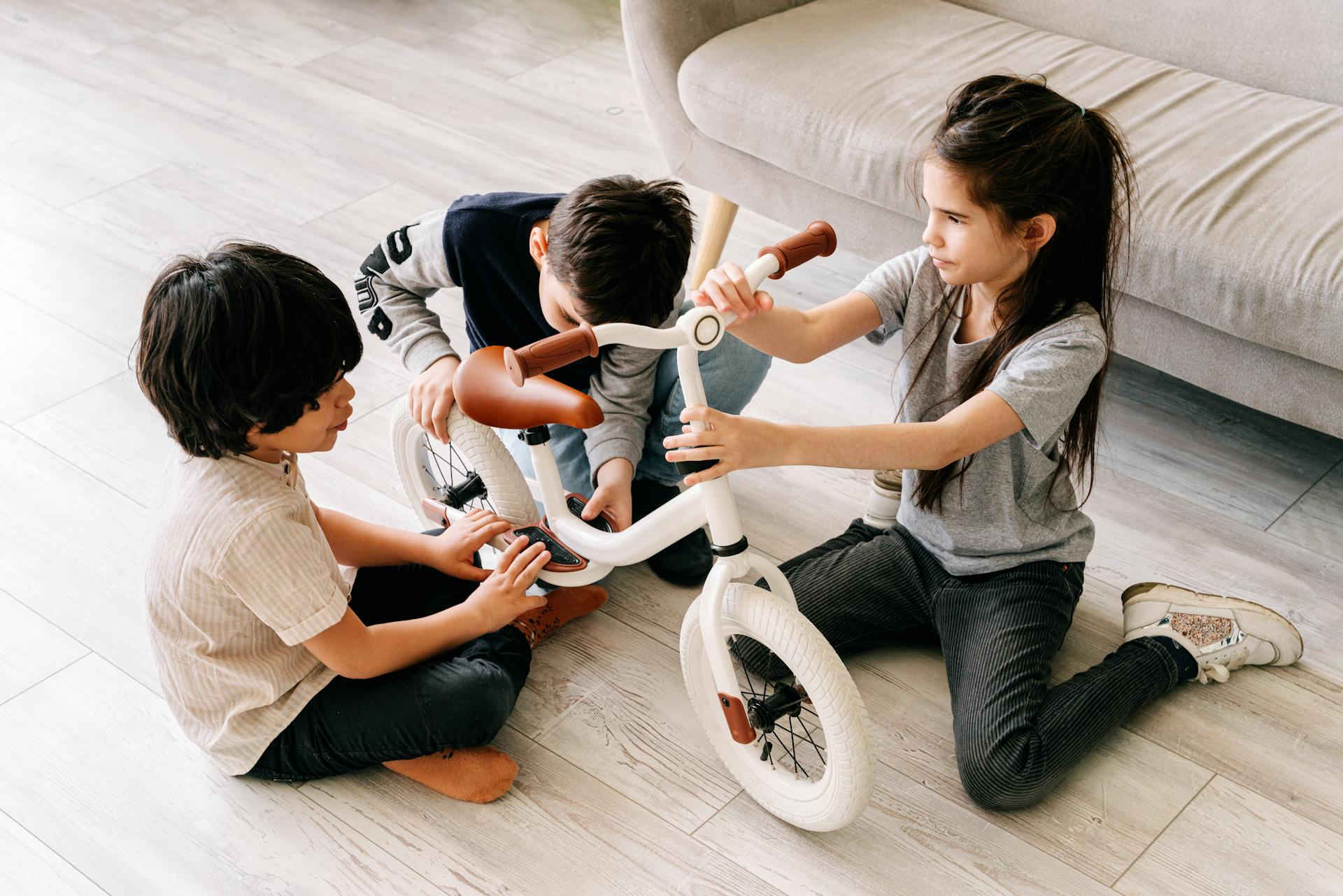 Children play on a vinyl floor together.