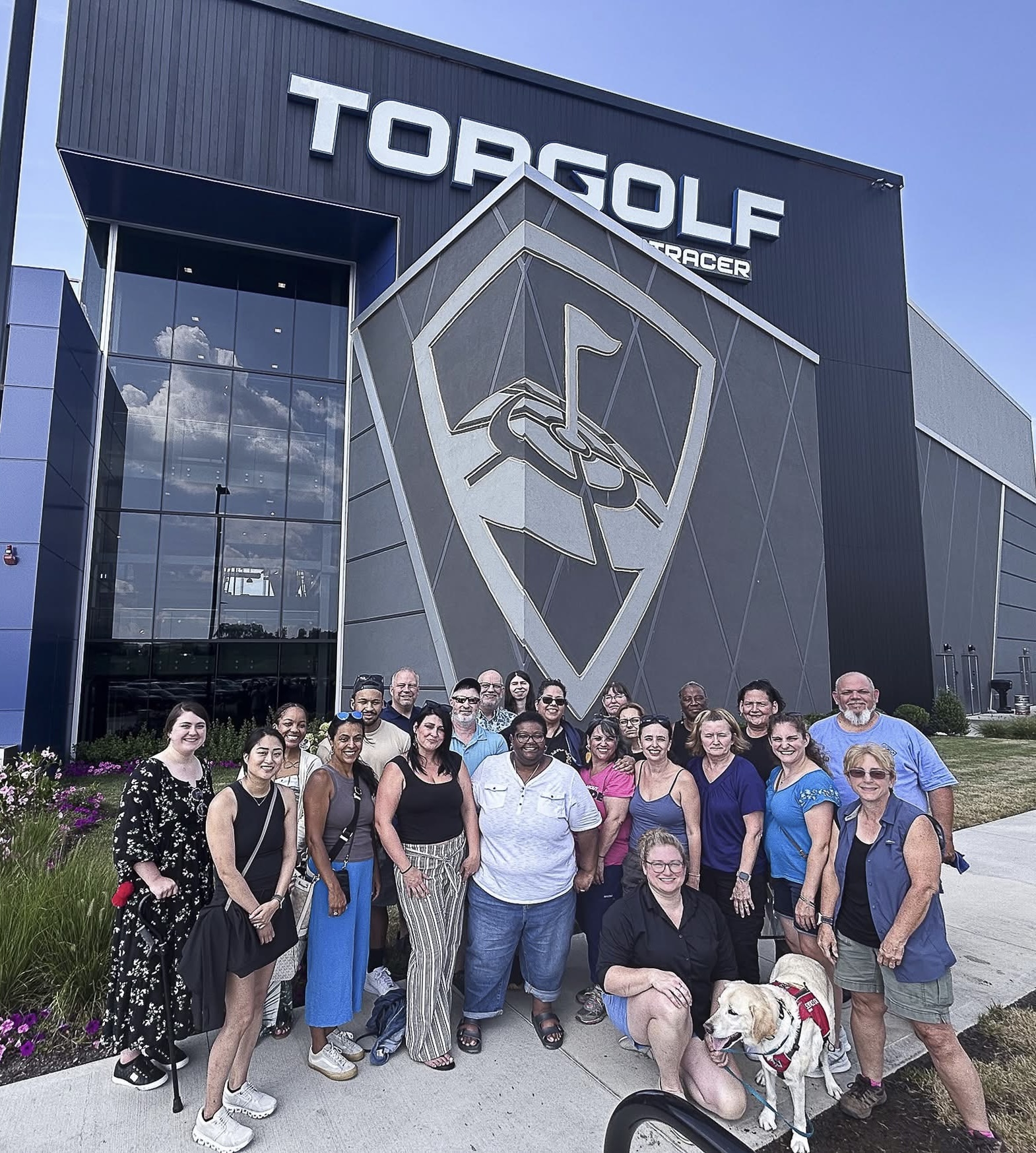 Group of DEAF, Inc. staff making funny gestures for the picture with presenter, Justin Perez with “Visual Vernacular with Justin Perez” on a screen behind them.