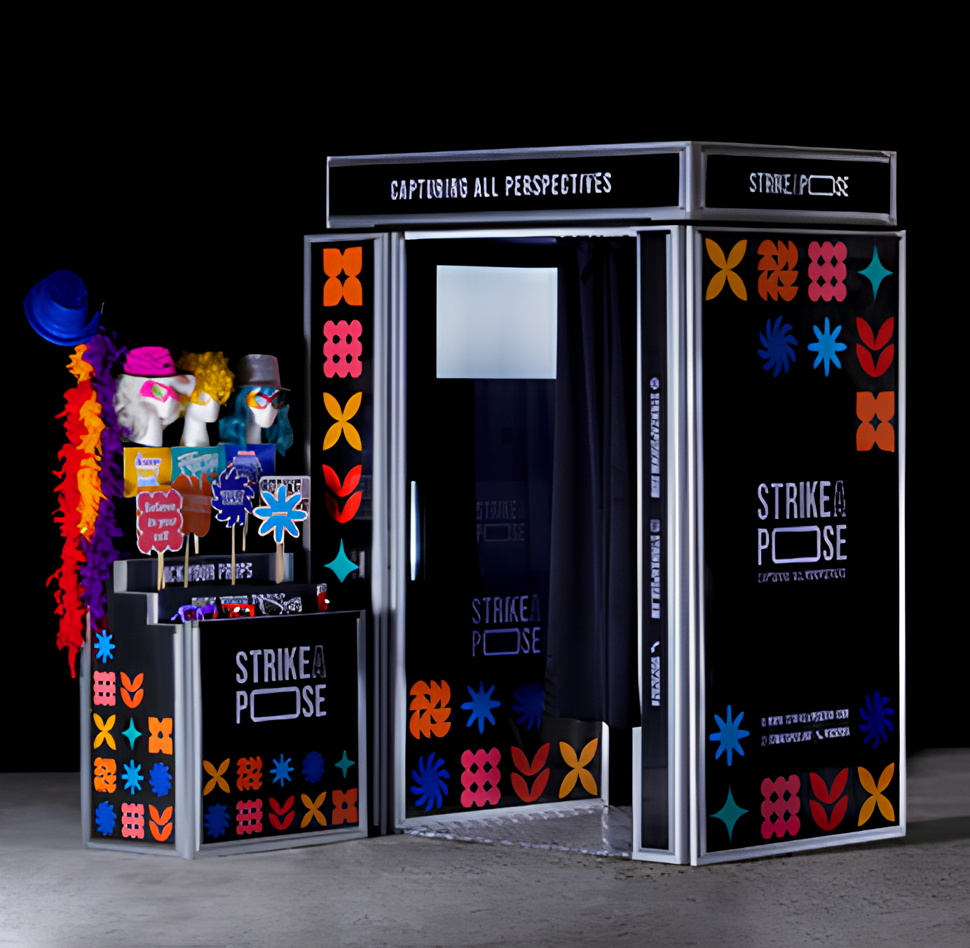 Two women in black dresses posing while a third woman in a black coat adjusts a ring light in a studio with blue and purple lighting.