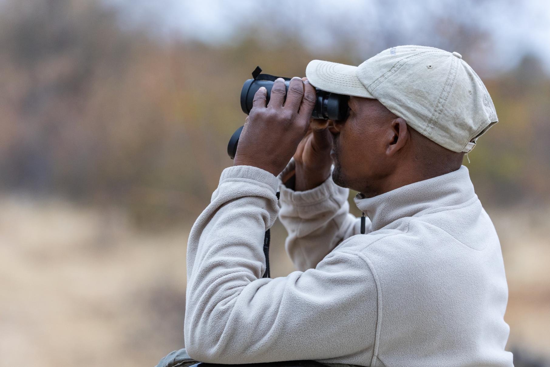 Guide spotting wildlife at the Central Tuli Game Reserve in Botswana.