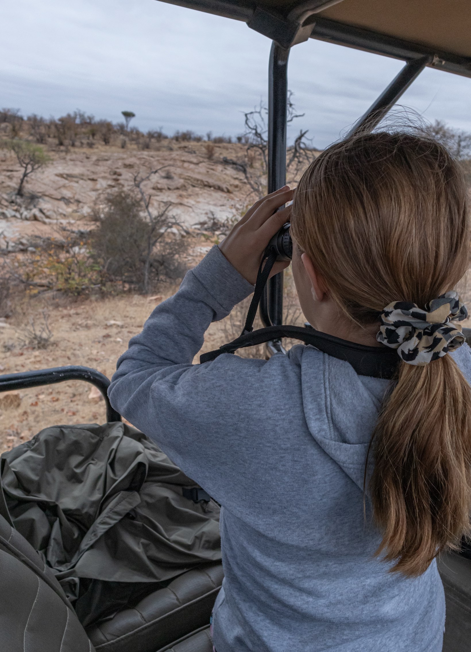 Child spotting wildlife at the Central Tuli Game Reserve in Botswana.