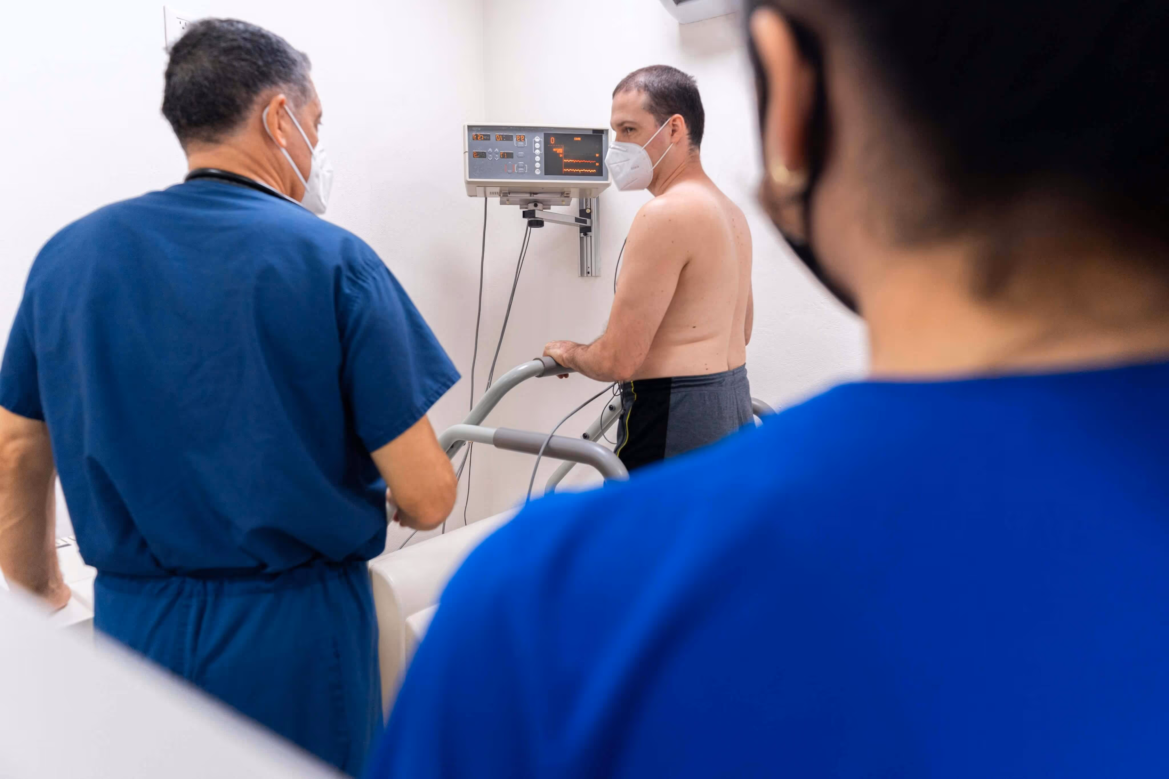 Healthcare team supporting patient in clinical assessment room