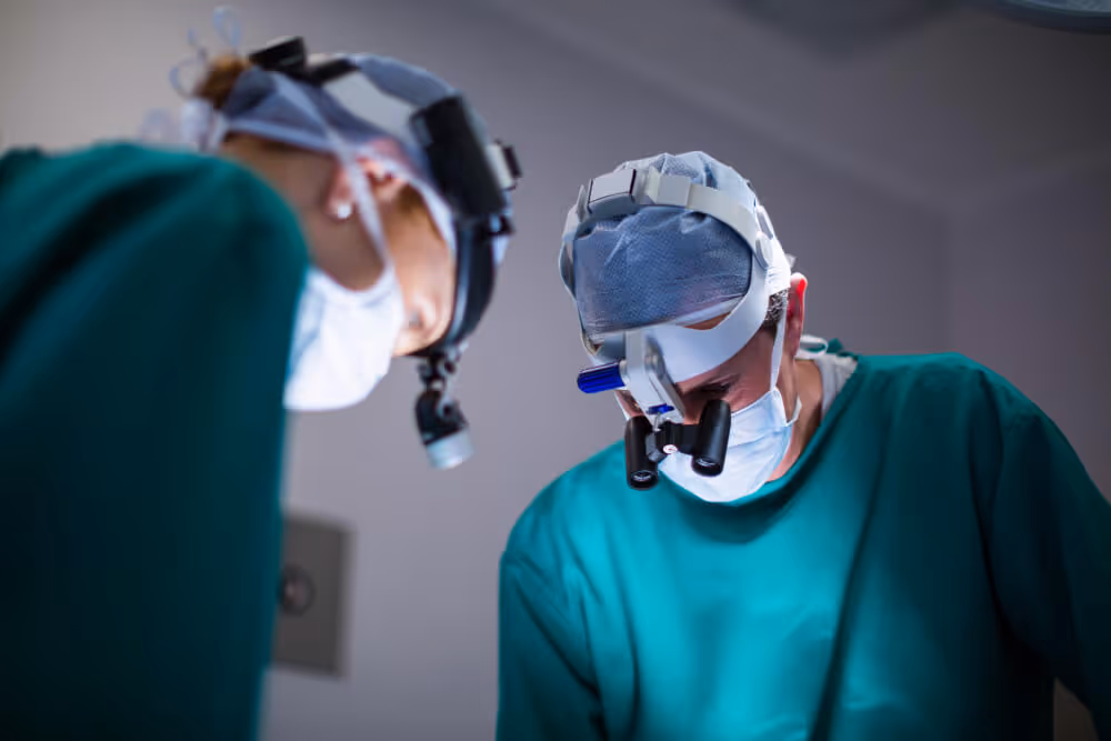 Surgeons performing operation under surgical lights