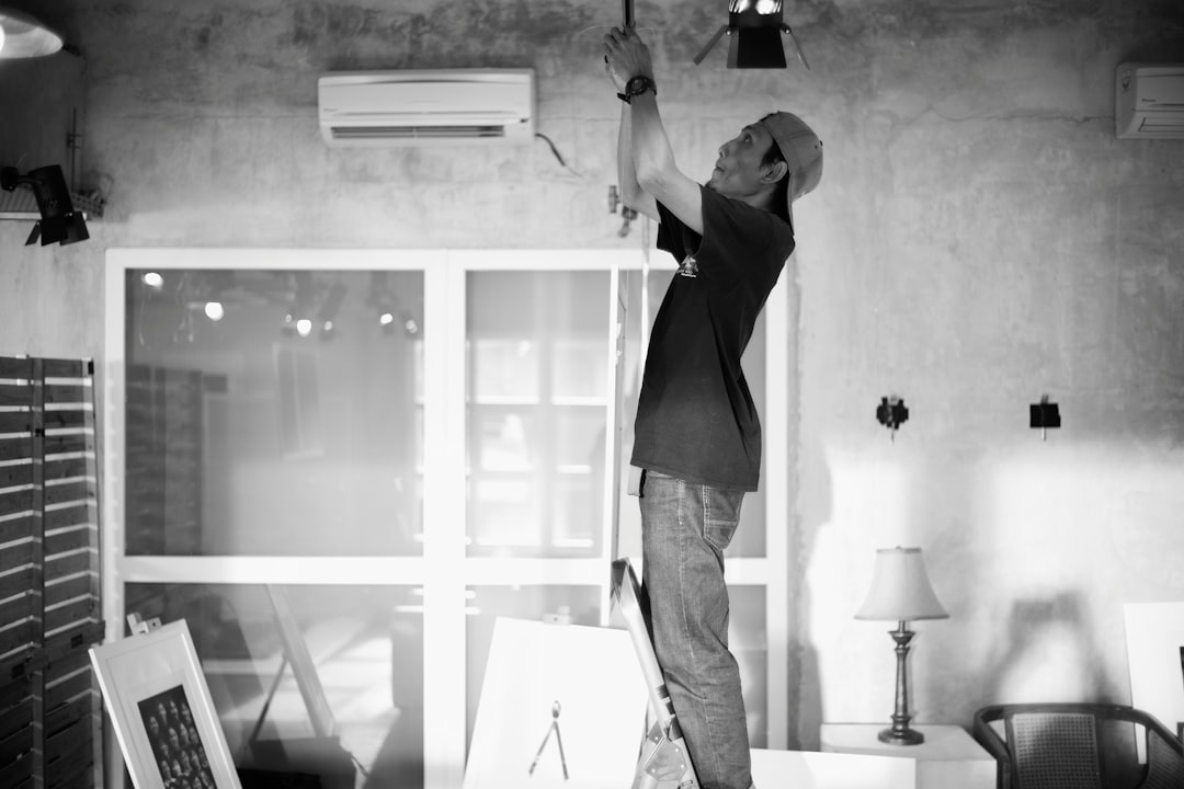 person mounting the indoor unit bracket - ductless AC installation