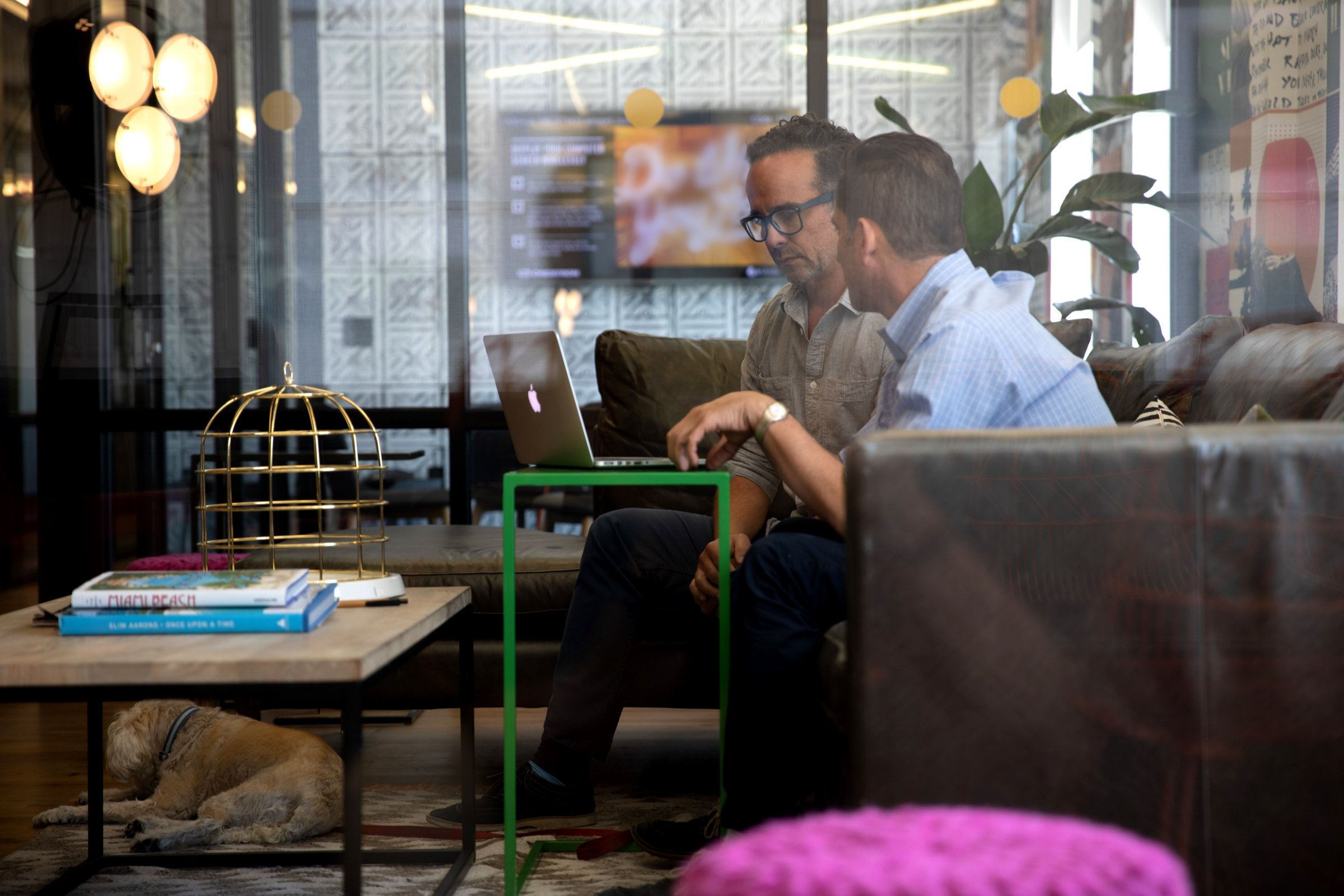 Mok2 principals discussing a project while sitting on a couch