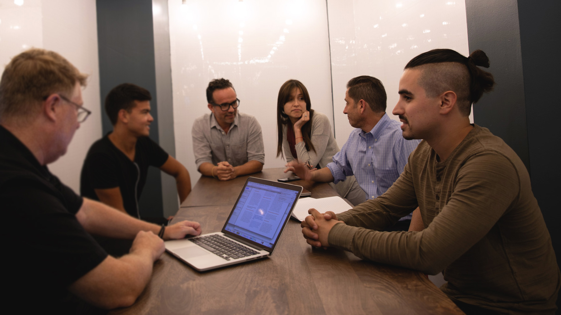 The mok2 team meets in a conference room