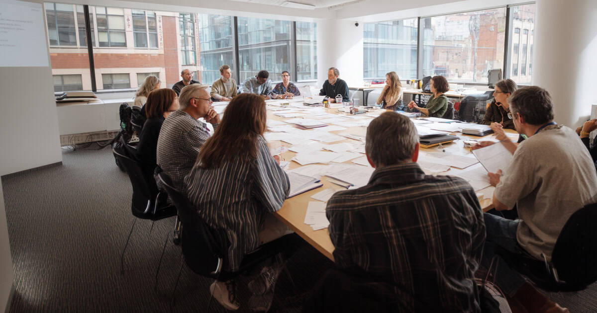 Small team discussing policy for IT services.