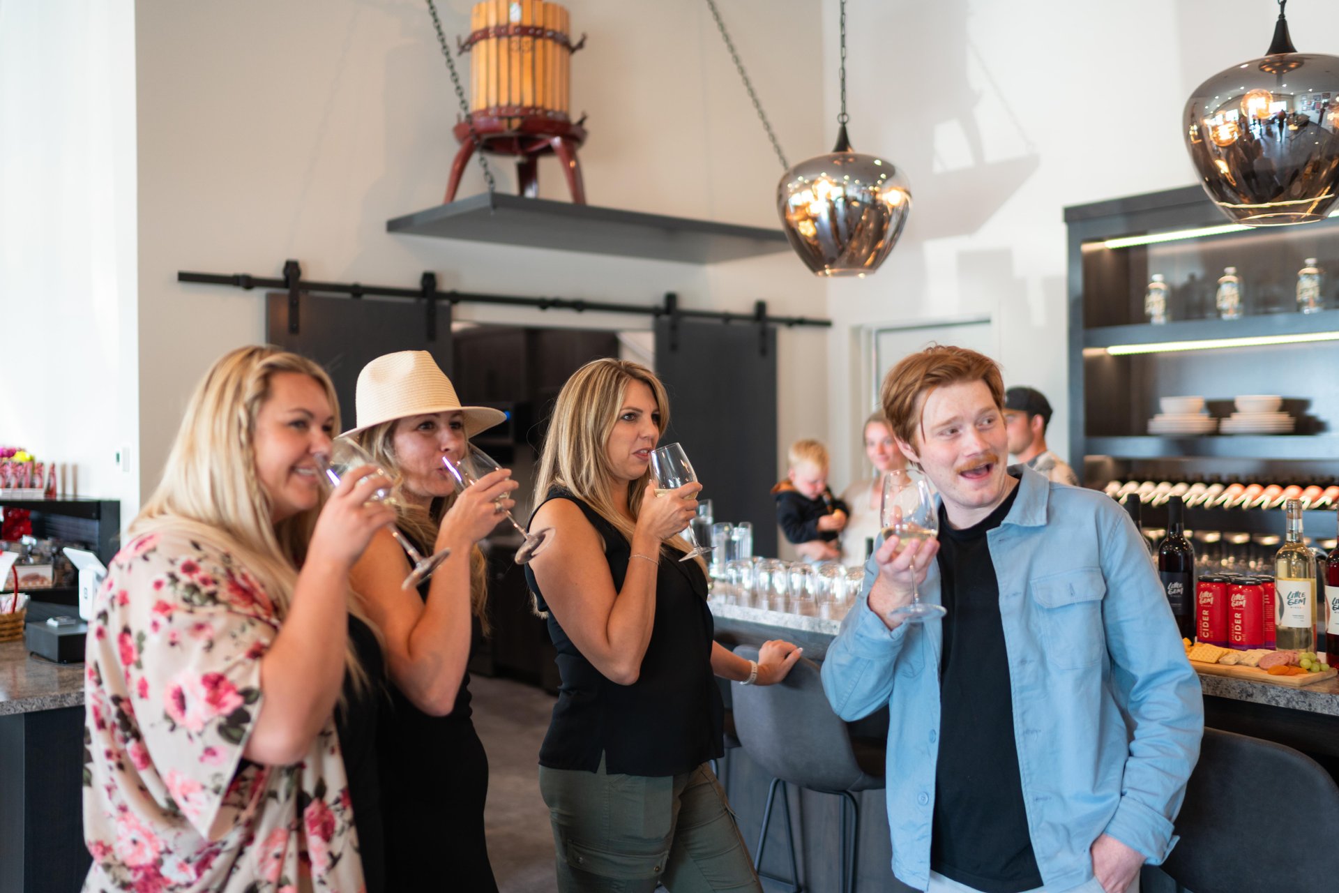 Group of people enjoying local haskap wine at Little Gem Winery