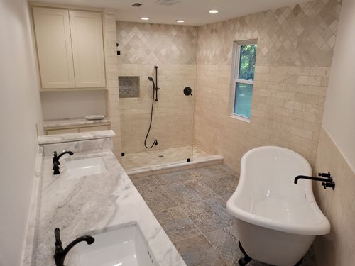 Welder leaning into work on angled metal project