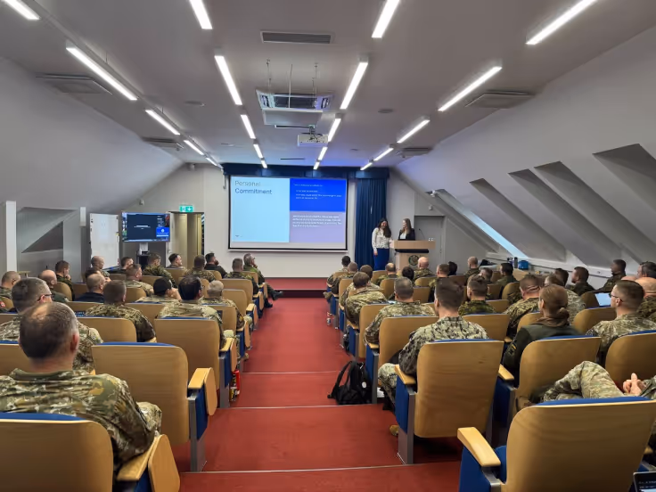 Officers listening to a presentation on Agile led by Magebit's Agile Coaches