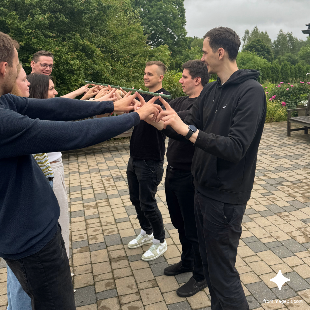 Warm-up game: Helium stick. Team members try to lower a stick to the ground using only their index fingers.