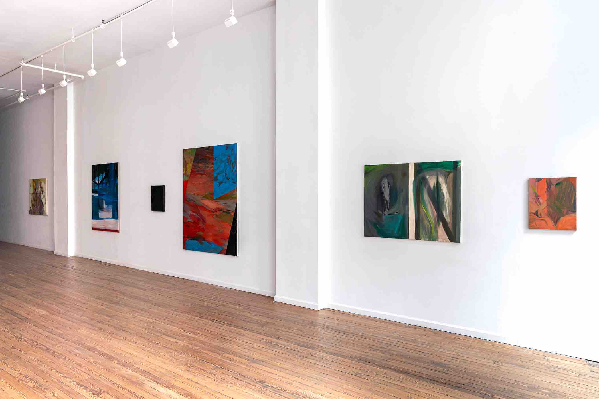 Art gallery interior with six abstract paintings displayed on white walls above a light wooden floor.
