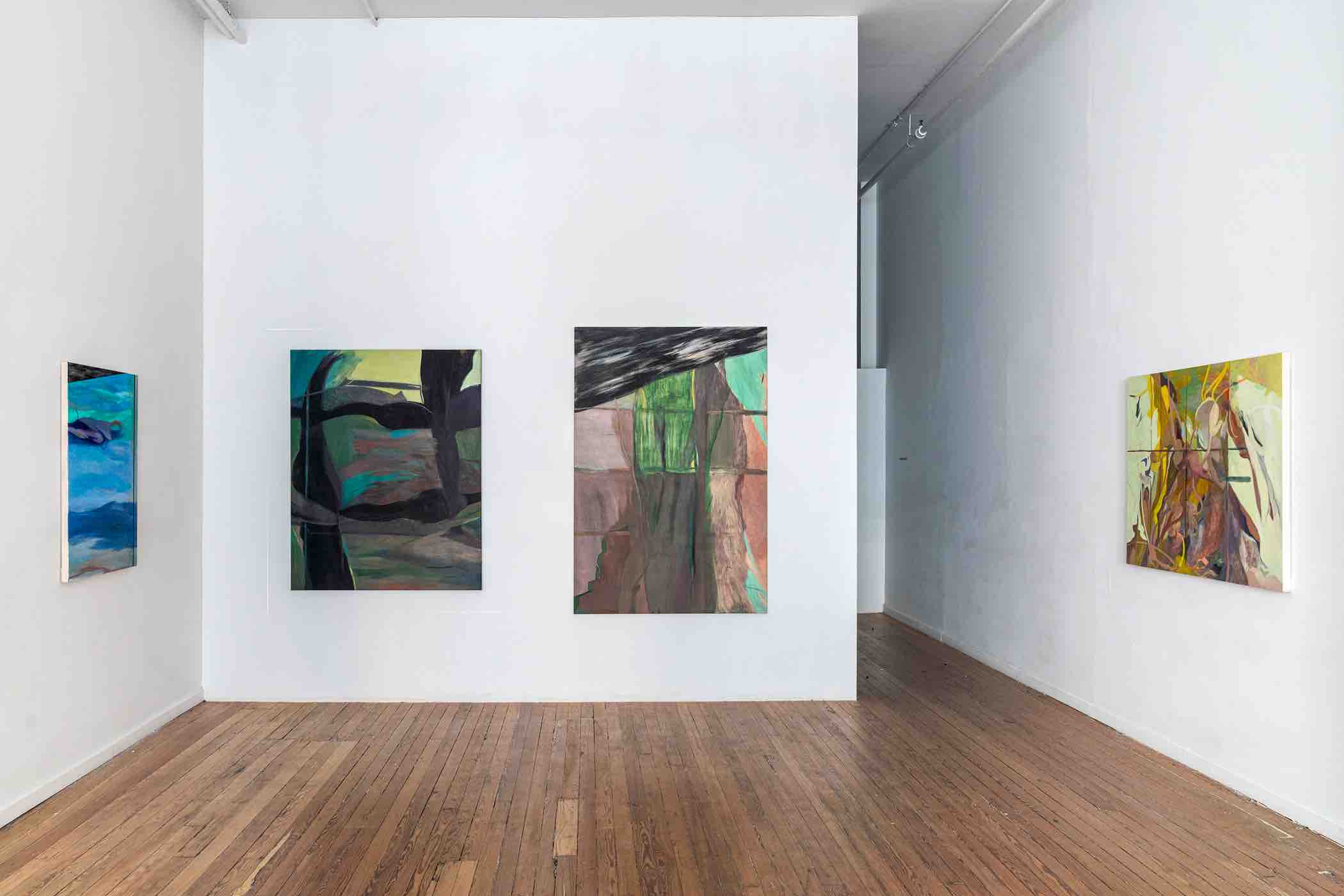 Gallery room with wooden floor and four abstract paintings on white walls.