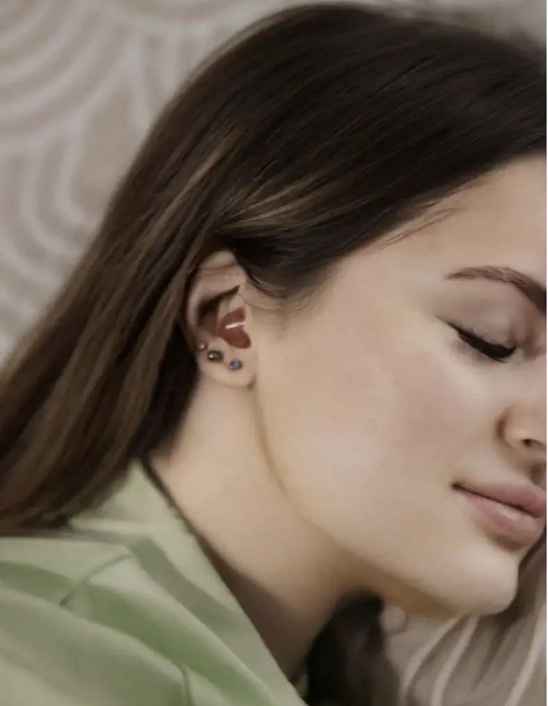 women sleeping with sleeping earplugs in her ears