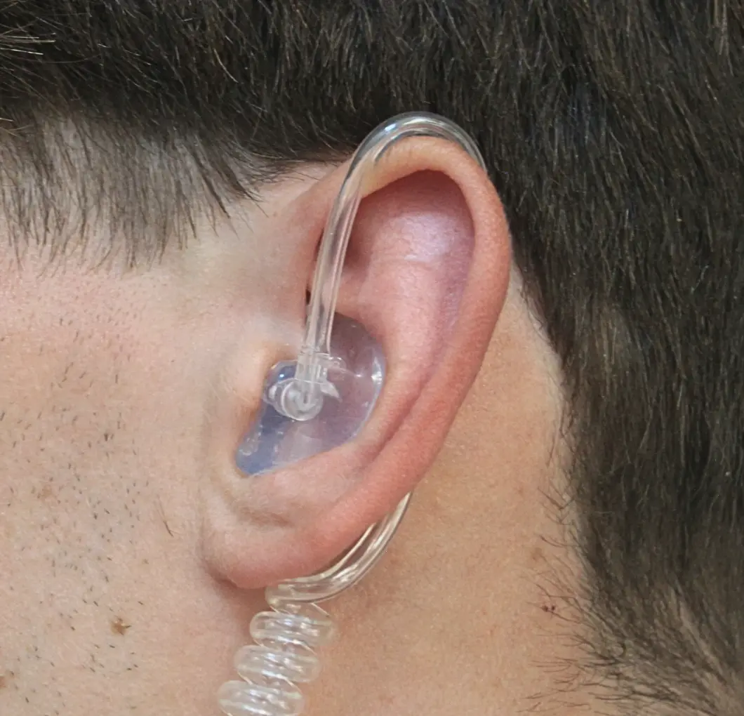 snugs pro comms in mans ear