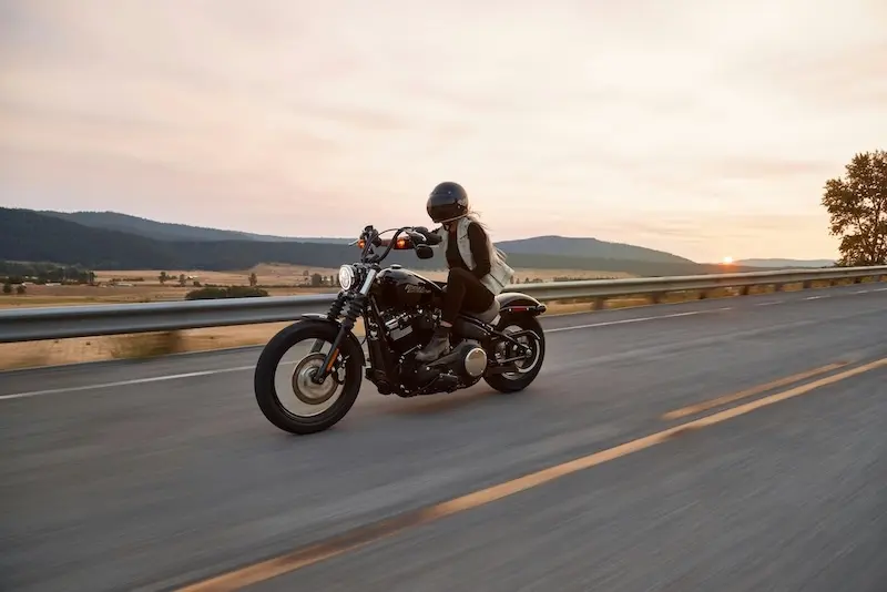 man riding motorcycle on road