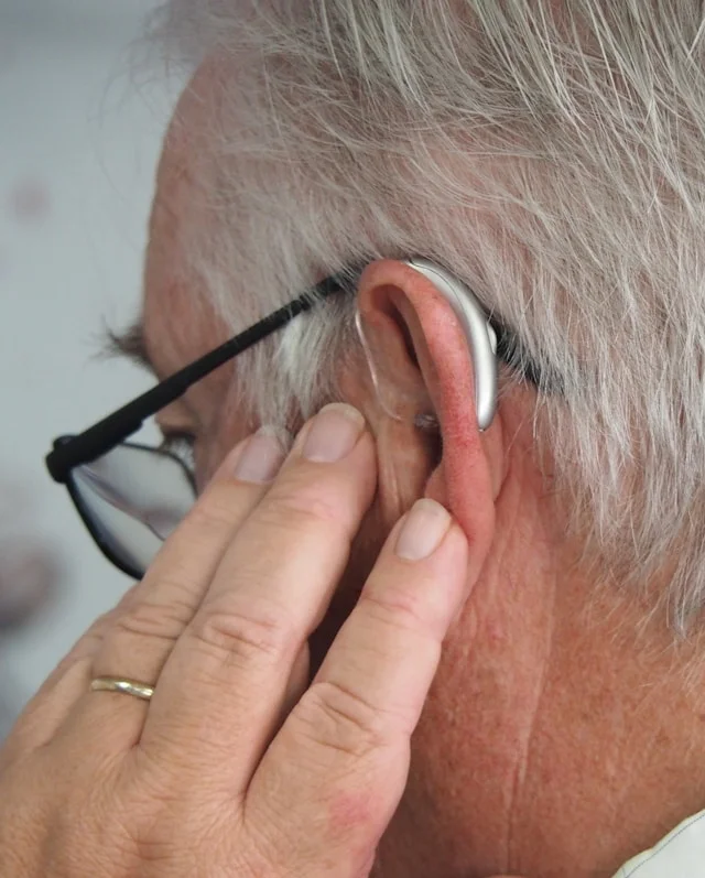 man wearing hearing aid and glasses